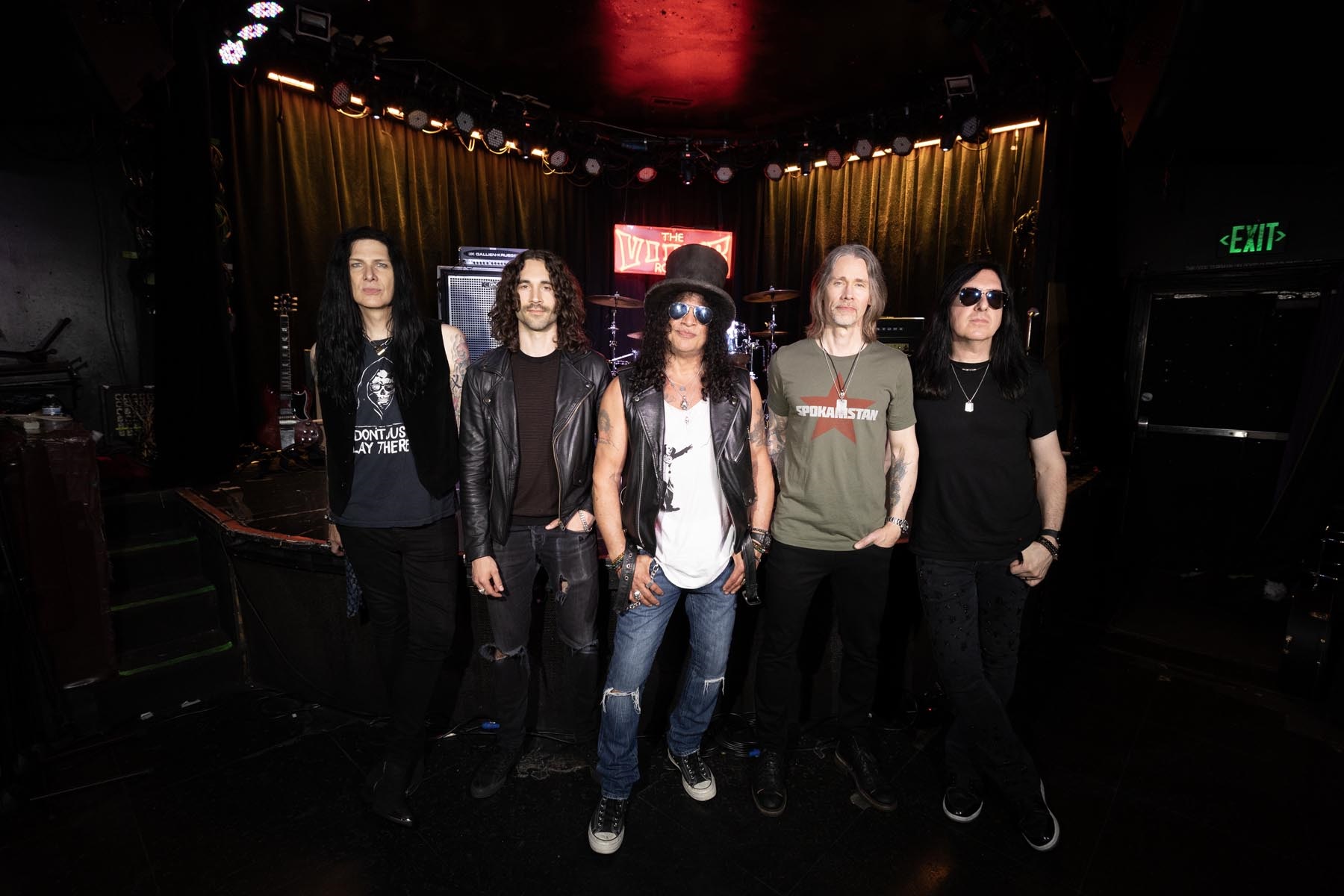 Slash wearing his signature top hat and sunglasses stands with Todd Kerns, Frank Sidoris, Myles Kennedy and Brent Fitz inside the Viper Room in Los Angeles.