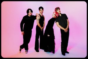 Los Angeles alternative rock band wilt in a group promotional photo against a pink background.