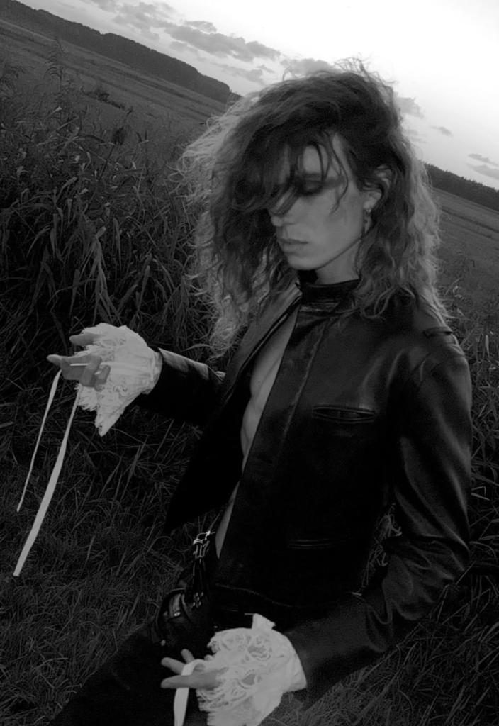 2hollis in a black leather outfit photographed outdoors in black and white for his Pirouette album era.