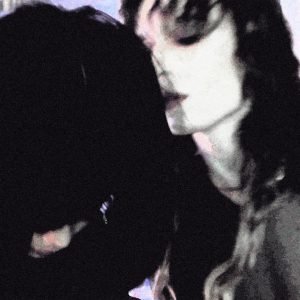 Grainy, dark close-up portrait of 2hollis with his face partially obscured, accompanying his 2026 single “Sex.”