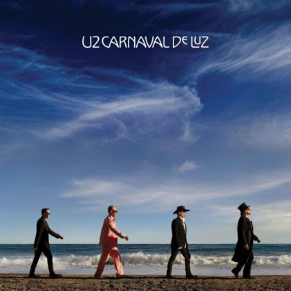 U2 Carnaval De Luz album cover featuring the four band members walking along a beach beneath a dramatic blue sky